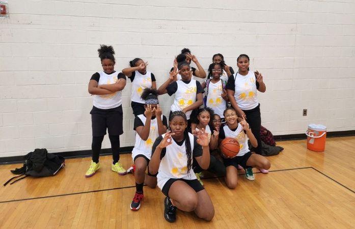 girls basketball team posing